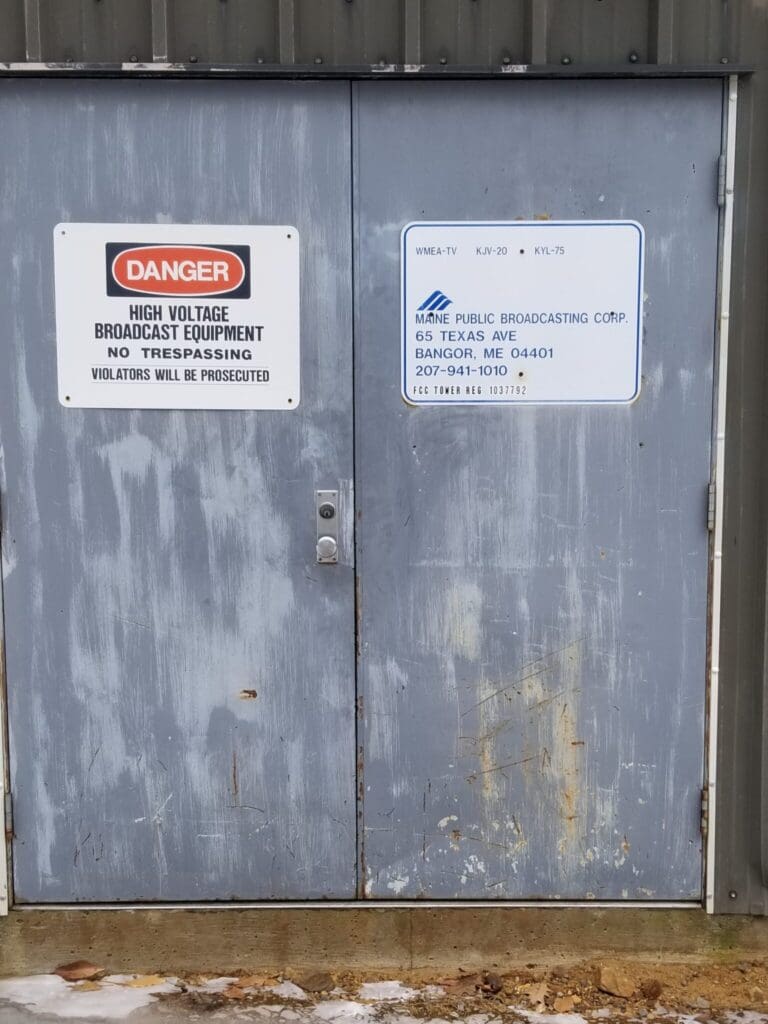 photo of signs on door danger high voltage broadcast equipment no trespassing