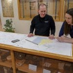 steve salsbury and tara hartson looking over a survey map