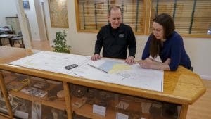 steve salsbury and tara hartson looking over a survey map