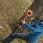 tara hartson using surveying equipment